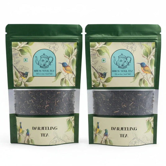 Two green pouches of premium Darjeeling tea with bird and teapot illustrations