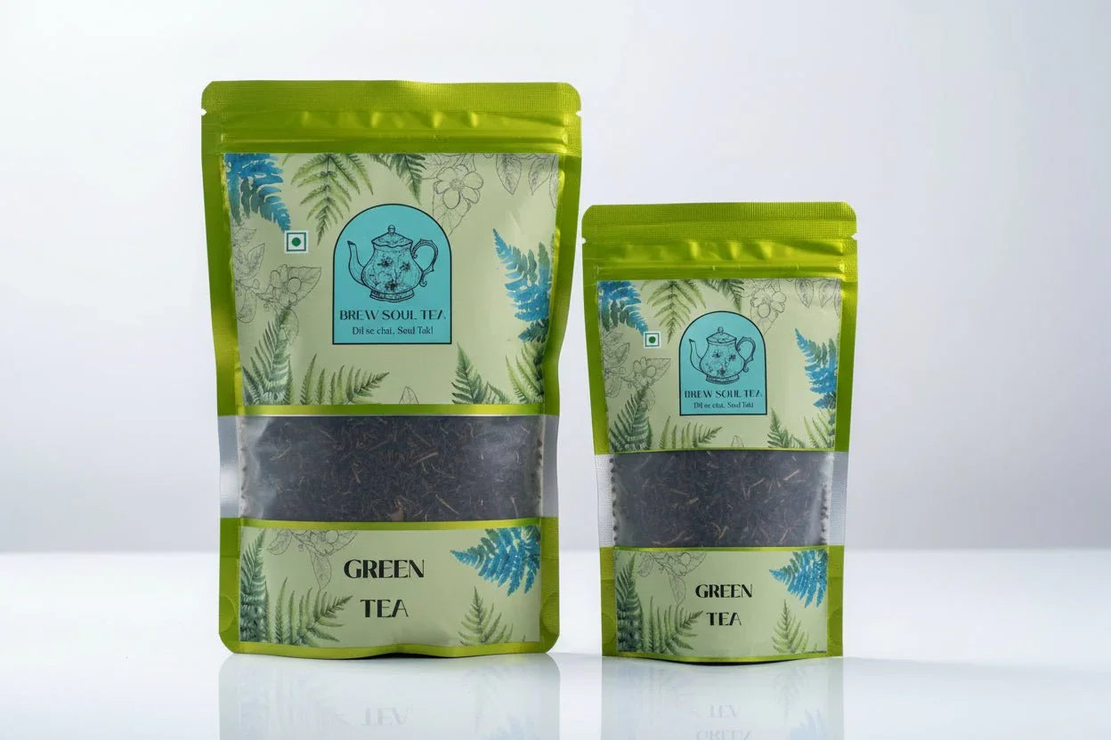 Two pouches of loose leaf Darjeeling green tea in resealable green packaging with fern design