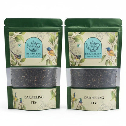 Two green pouches of premium Darjeeling tea with bird and teapot illustrations